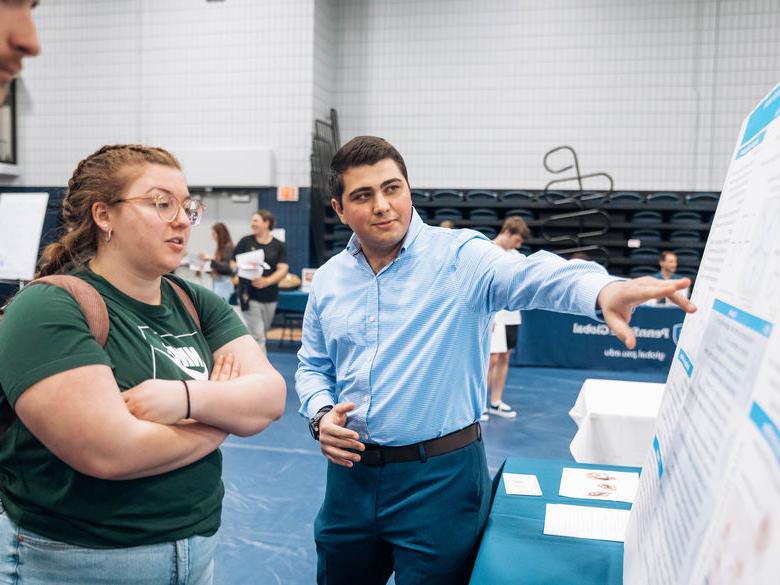 Student shares his poster presentation