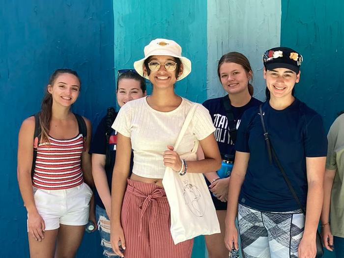 Five students stand to pose for photo